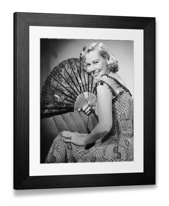 Framed Print : Portrait of blonde woman holding fan Framed Print : Portrait of blonde woman holding fan