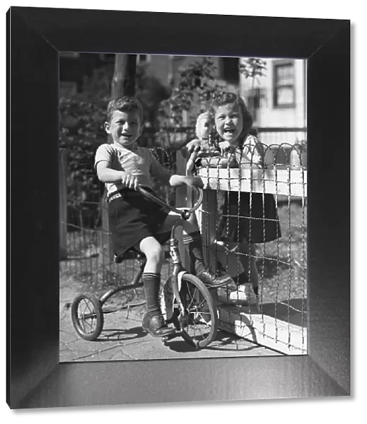 Boy on tricycle w  /  girl