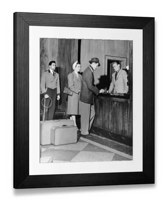 Framed Print : Couple signing in at hotel lobby Framed Print : Couple signing in at hotel lobby