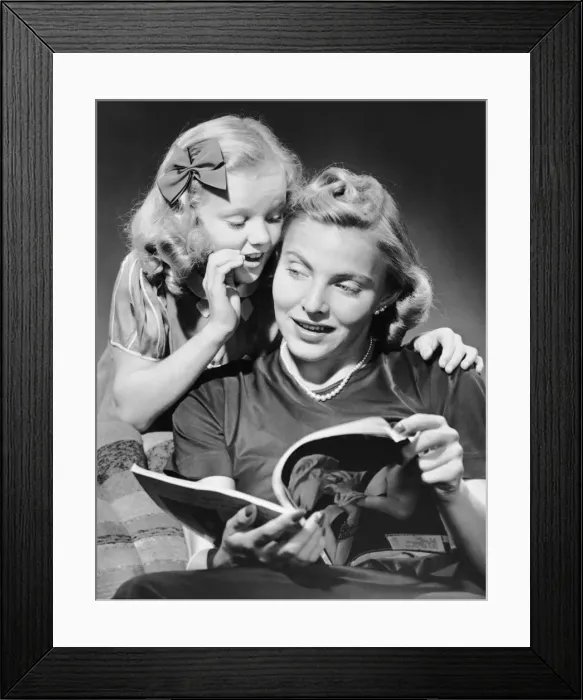 Framed Print : Daughter whispering into mothers ear Framed Print : Daughter whispering into mothers ear