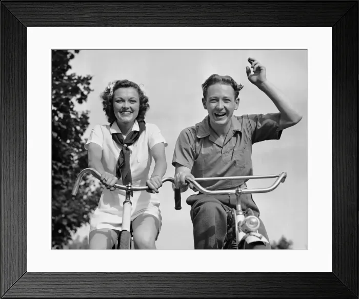 Framed Print : Young couple riding bicycles Framed Print : Young couple riding bicycles