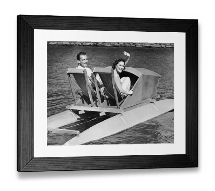 Framed Print : Couple on lake in paddle boat