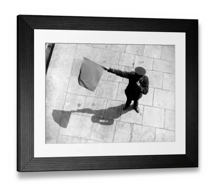 Framed Print : Train station guard waving flag