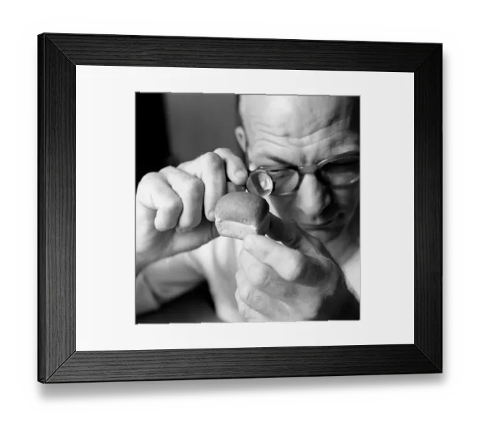 Framed Print : Man looking at miniture loaf of bread through magnifying glass Framed Print : Man looking at miniture loaf of bread through magnifying glass