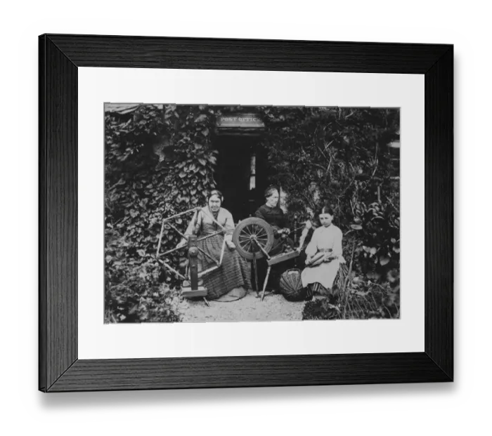 Framed Print : Spinners. circa 1885: Women spinning and carding wool outside the local