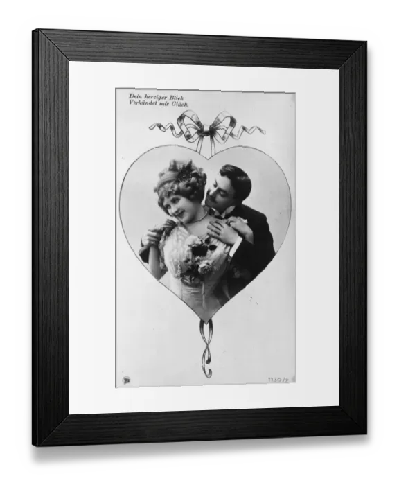 Framed Print : Coy Card. circa 1900: A German postcard; within a heart shaped frame a Framed Print : Coy Card. circa 1900: A German postcard; within a heart shaped frame a