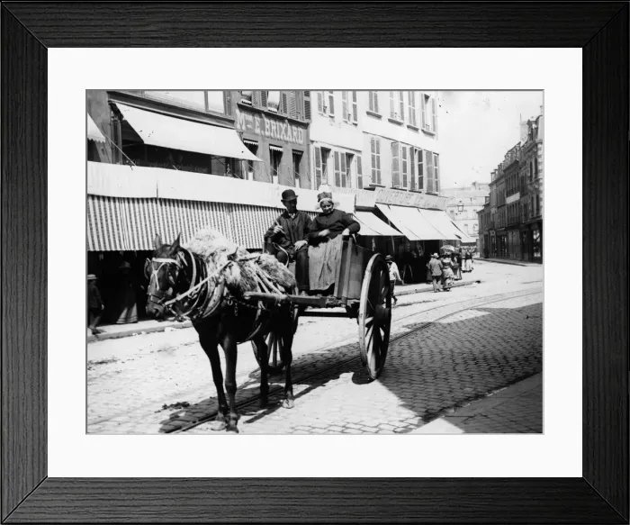 Framed Print : France. circa 1900: Couple driving in a horse and cart up a street in France Framed Print : France. circa 1900: Couple driving in a horse and cart up a street in France