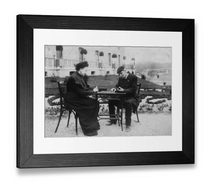 Framed Print : Dominoes. circa 1910: An old couple play a game of dominoes in the garden of an alms house Framed Print : Dominoes. circa 1910: An old couple play a game of dominoes in the garden of an alms house