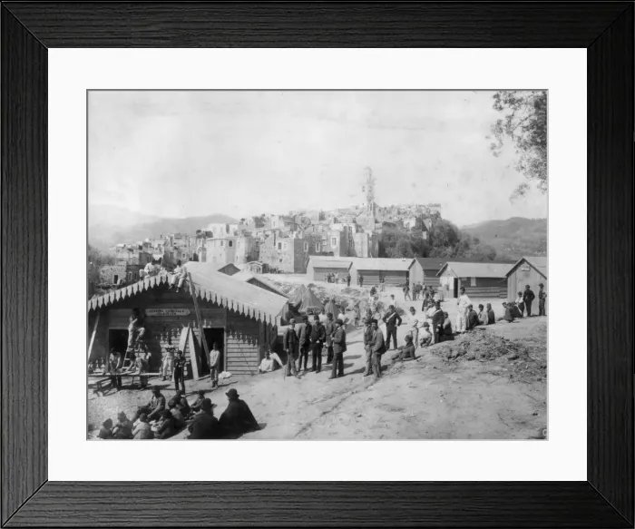 Framed Print : San Remo. 1886: A group of men outside a group of temporary huts built Framed Print : San Remo. 1886: A group of men outside a group of temporary huts built