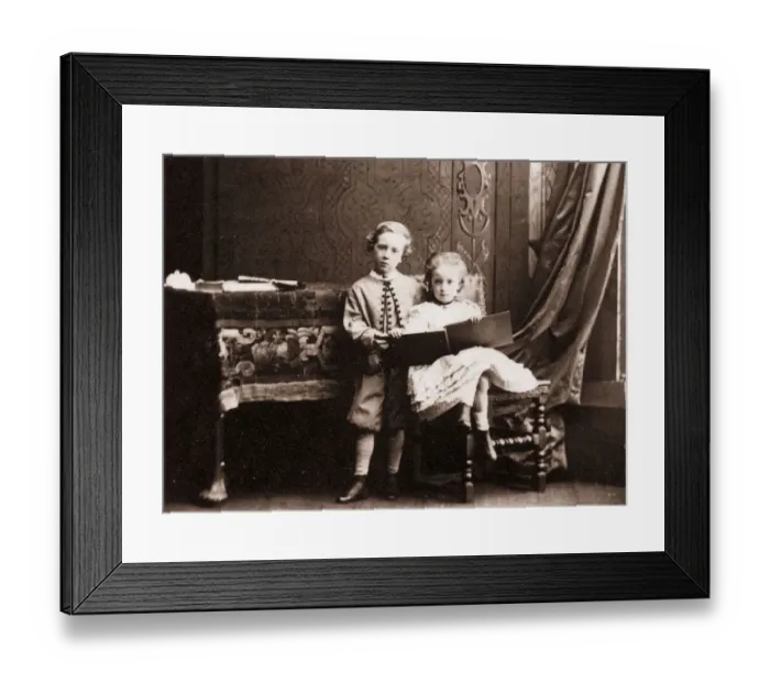 Framed Print : My Sister. circa 1860: A little boy shares a book with his sister Framed Print : My Sister. circa 1860: A little boy shares a book with his sister
