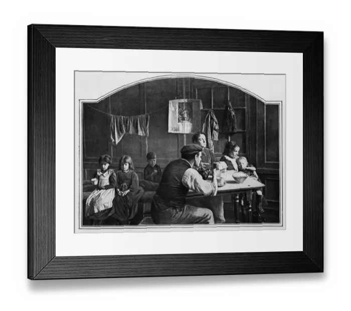 Framed Print : Tea Time. circa 1901: A working family having their tea in a London slum