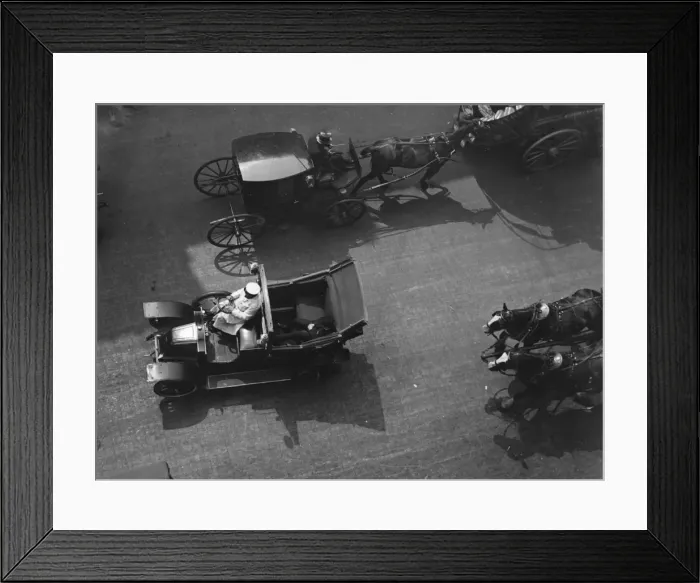 Framed Print : Taxicabs. circa 1907: A motorised taxicab passing a growler, a four-wheeled horsedrawn cab