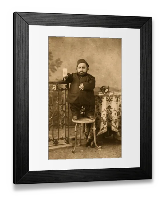 Framed Print : A Leg Up. circa 1890: A dwarf stands on a stool to have his portrait photographed Framed Print : A Leg Up. circa 1890: A dwarf stands on a stool to have his portrait photographed