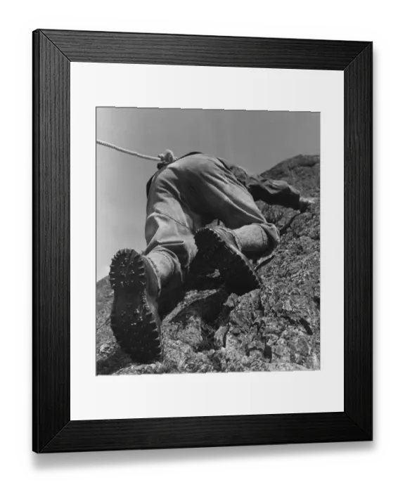 Framed Print : A climber making his way up a rock face Framed Print : A climber making his way up a rock face