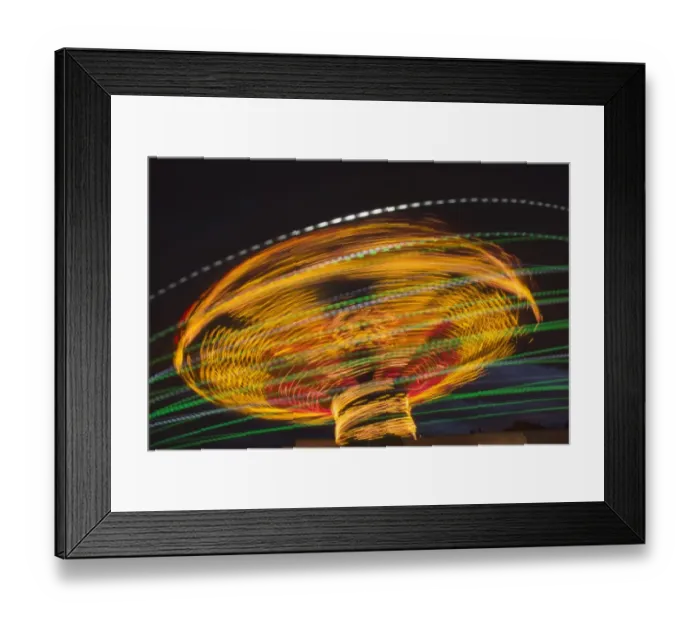 Framed Print : Fairground ride light effect at night