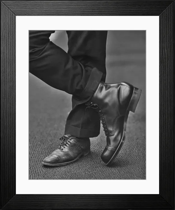 Framed Print : Odd Shoes. A man wearing an average size shoe