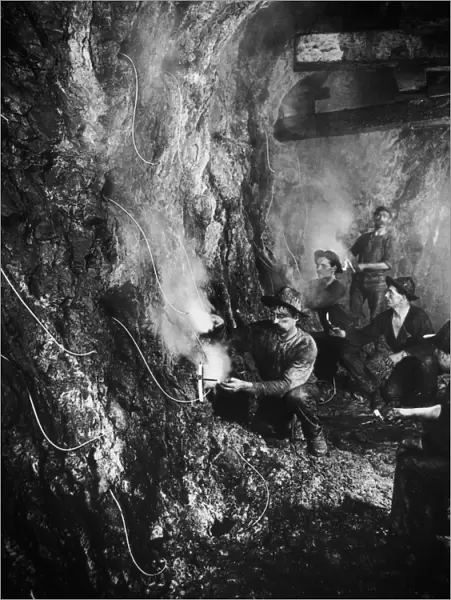 Iron Mine. Workers laying explosives in an iron mine, 1880