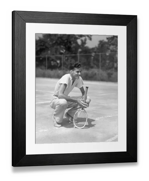 Framed Print : Young Man Smiling Squatting Holds Tennis Racquet A Framed Print : Young Man Smiling Squatting Holds Tennis Racquet A