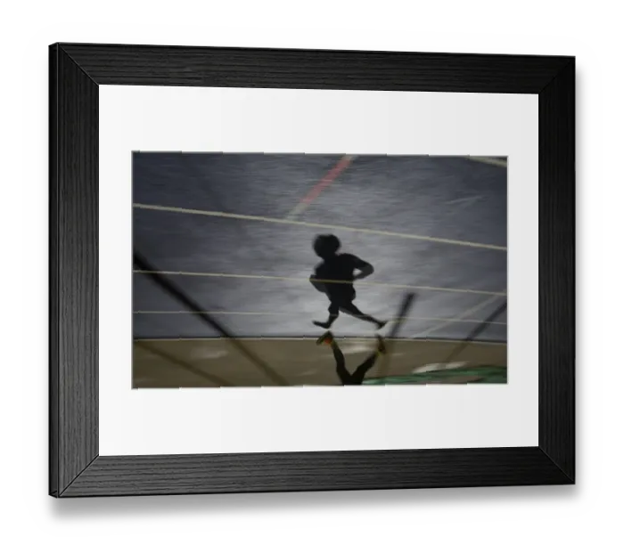 Framed Print : Shadow of a man running in sports stadium Framed Print : Shadow of a man running in sports stadium