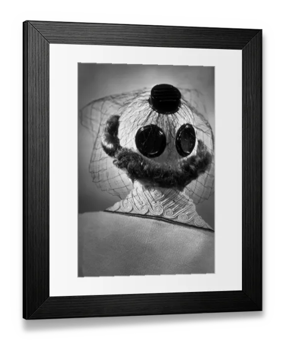 Framed Print : A New Hat. 15th March 1937: The back view of a hat decorated with large buttons and net,