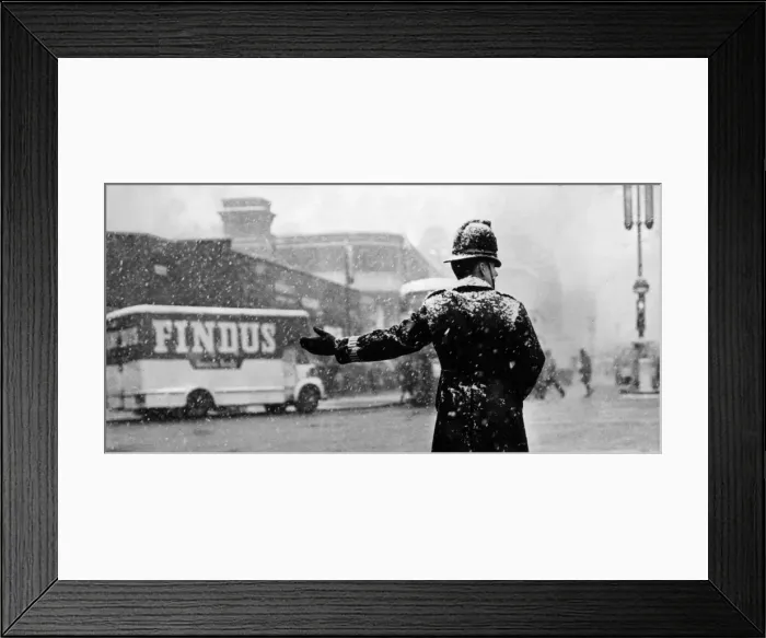 Framed Print : City Snow. 20th November 1965: A policeman directs traffic on a snowy day Framed Print : City Snow. 20th November 1965: A policeman directs traffic on a snowy day