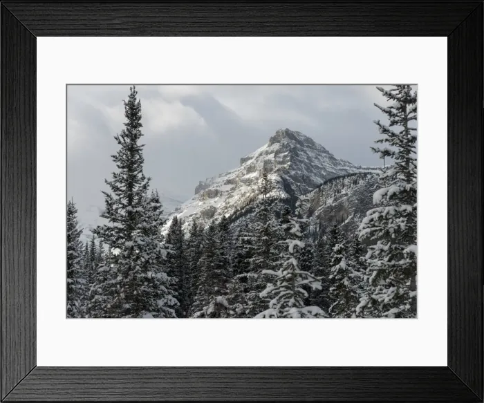 Framed Print : Rugged mountain peak with snow under a cloudy sky Framed Print : Rugged mountain peak with snow under a cloudy sky
