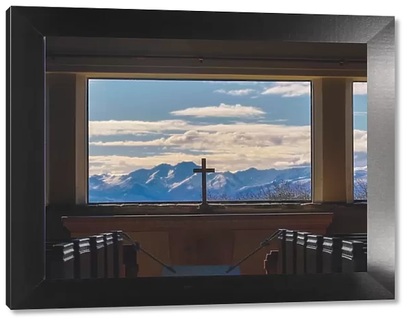 A cross inside Church with Mountain background