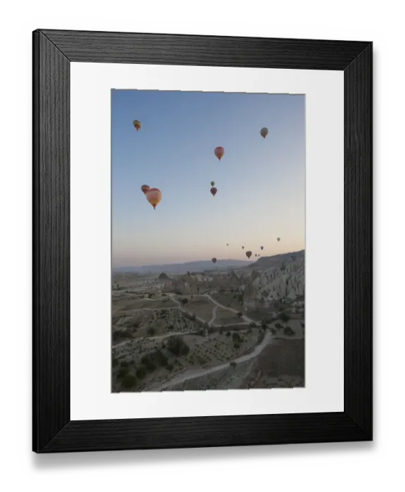 Framed Print : Hot air balloons flying over rocky landscape