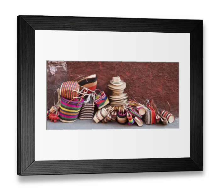 Framed Print : Woven souvenirs on display on a sidewalk against a wall Framed Print : Woven souvenirs on display on a sidewalk against a wall