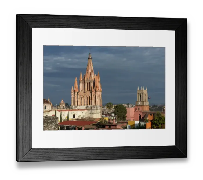 Framed Print : Church and cityscape under cloudy sky, with a hot air balloon in the distance Framed Print : Church and cityscape under cloudy sky, with a hot air balloon in the distance