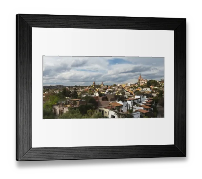 Framed Print : Cityscape and church in the distance under cloudy sky Framed Print : Cityscape and church in the distance under cloudy sky