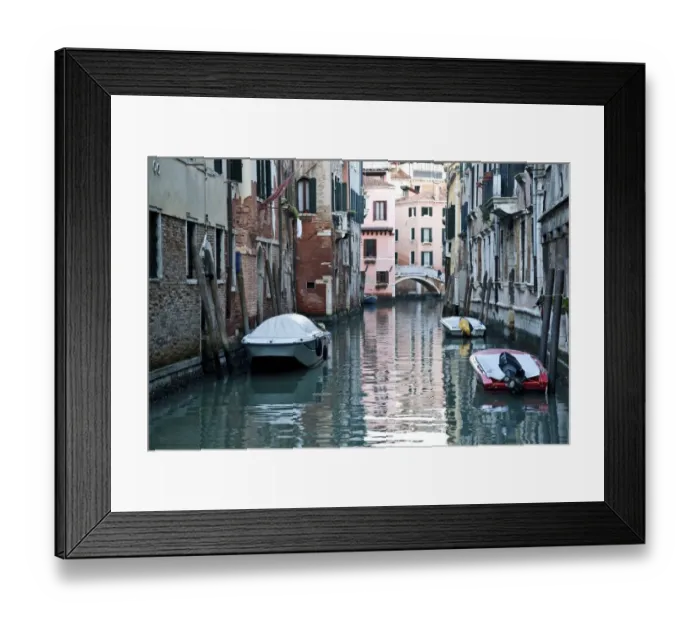 Framed Print : Boats moored along buildings in a tranquil canal Framed Print : Boats moored along buildings in a tranquil canal