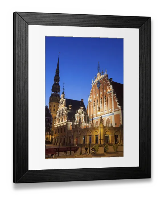 Framed Print : Latvia, Riga, Illuminated House of the Blackheads and St. Peters Church against blue sky