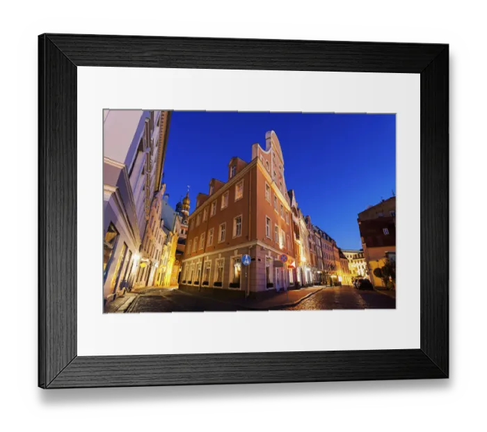 Framed Print : Latvia, Riga, Corner of illuminated building against blue dusk sky Framed Print : Latvia, Riga, Corner of illuminated building against blue dusk sky