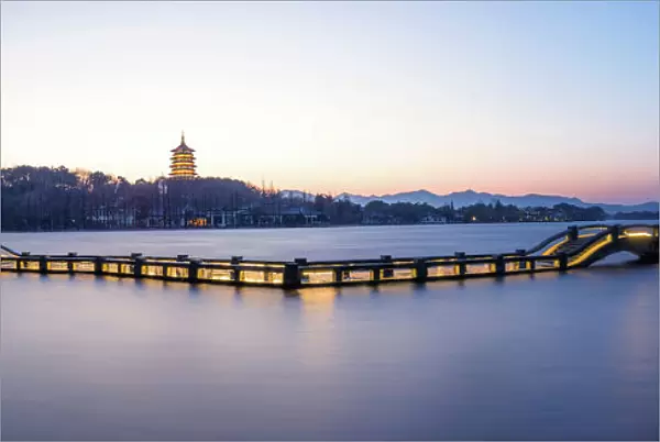 A zig zag bridge agsinst Leifeng Pagoda on the West Lake, Hangzhou
