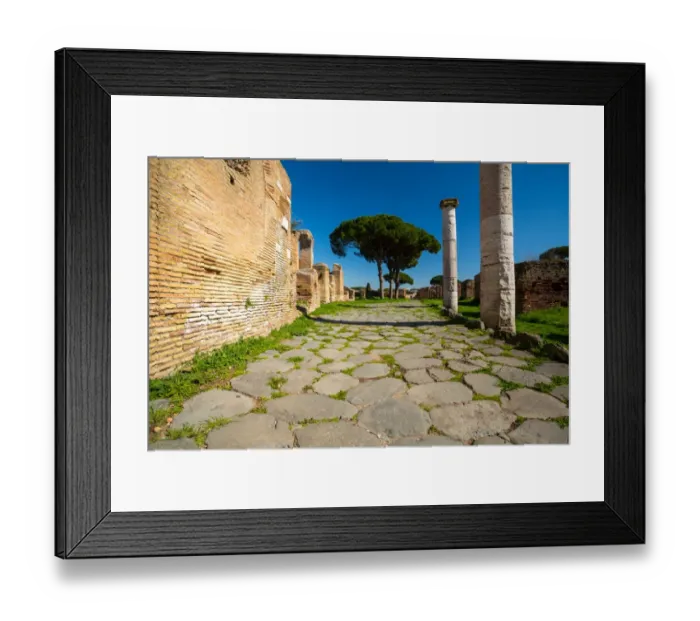 Framed Print : An ancient road in the ruins of the Ancient Roman harbour city of Ostia Antica in Rome, Italy
