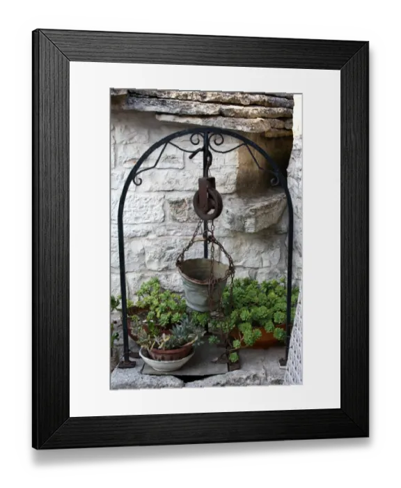 Framed Print : Old well and metal bucket near a Trullo house in Alberobello, near Bari, Apulia, southern Italy Framed Print : Old well and metal bucket near a Trullo house in Alberobello, near Bari, Apulia, southern Italy