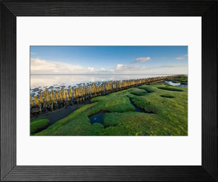 Framed Print : View over grasses, poles en tidal flats of the Wadden sea at Dutch Northcoast Framed Print : View over grasses, poles en tidal flats of the Wadden sea at Dutch Northcoast