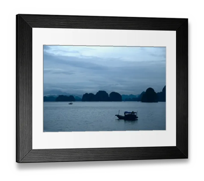 Framed Print : Small fishing boat at anchor under a moody sky, Halong Bay Framed Print : Small fishing boat at anchor under a moody sky, Halong Bay