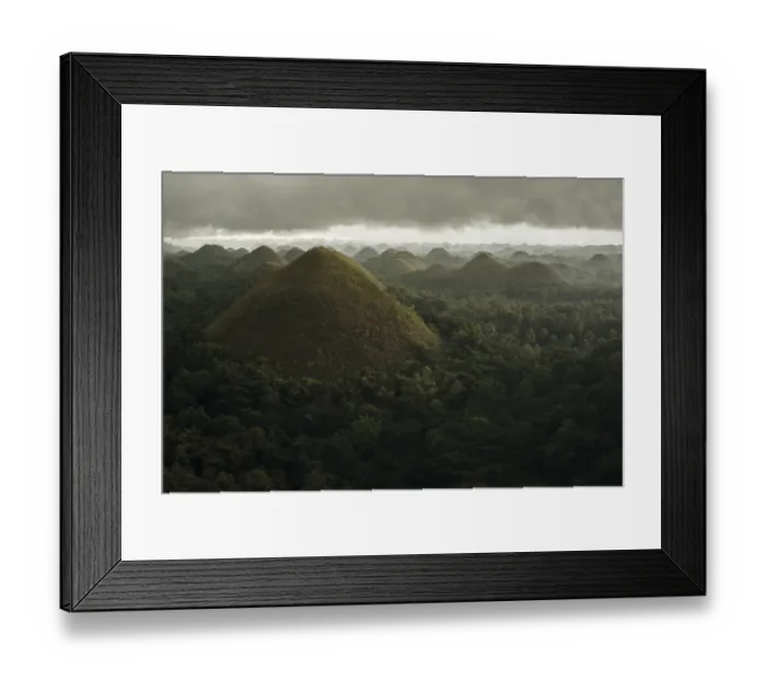 Framed Print : Chocolate hills landscape from Bohol Island, a big storm covers the sky making an interesting lighting effect Framed Print : Chocolate hills landscape from Bohol Island, a big storm covers the sky making an interesting lighting effect