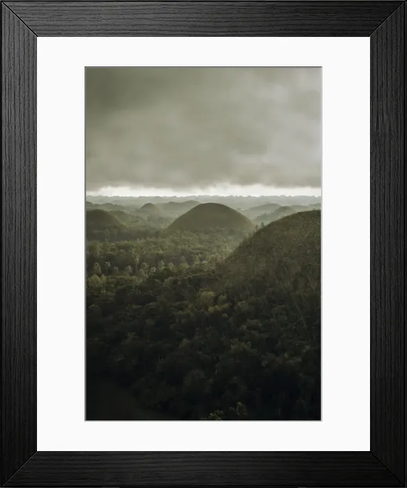 Framed Print : Chocolate hills landscape from Bohol Island, a big storm covers the sky making an interesting lighting effect Framed Print : Chocolate hills landscape from Bohol Island, a big storm covers the sky making an interesting lighting effect