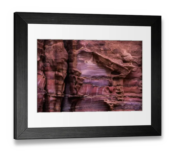 Framed Print : A rugged rock wall of colourful sandstone