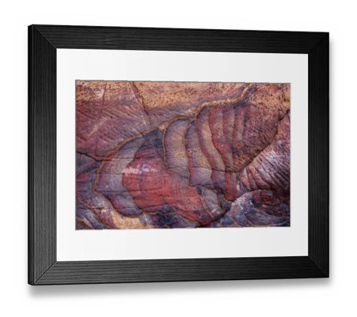 Framed Print : A colourful sandstone wall eroded in a design Framed Print : A colourful sandstone wall eroded in a design