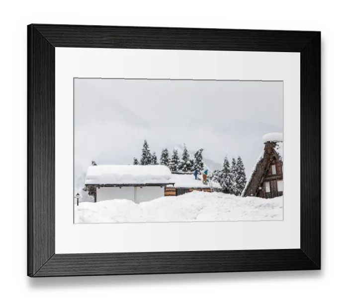 Framed Print : Men remove snow from roof during a winter storm