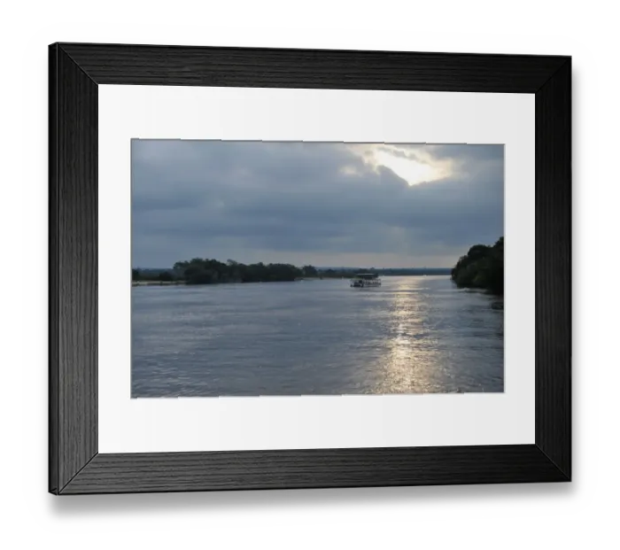 Framed Print : Evening cruise aside The Victoria Falls in Zambia at sunset Framed Print : Evening cruise aside The Victoria Falls in Zambia at sunset