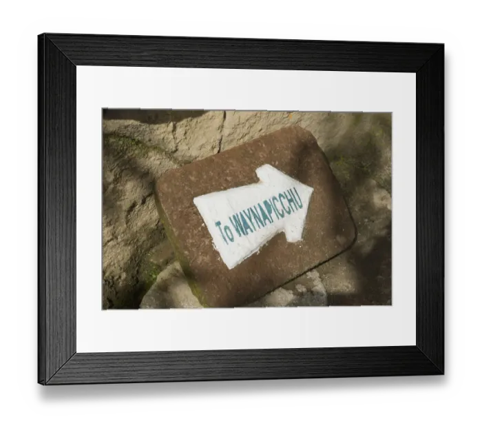 Framed Print : a sign on a rock pointing to the mountain wayna picchu Framed Print : a sign on a rock pointing to the mountain wayna picchu