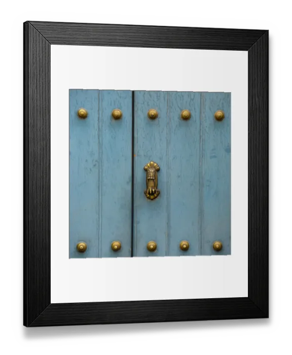 Framed Print : A Blue Door With Brass Decorative Knobs