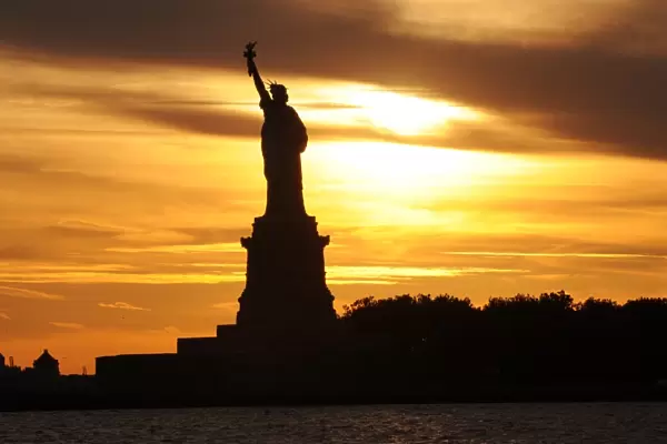 Silhouette of Statue Of Liberty during Sunset