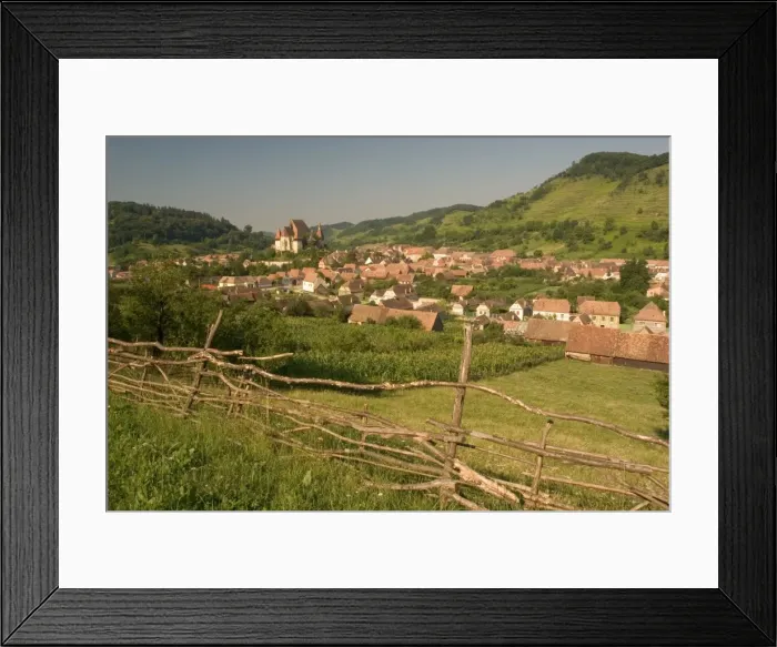 Framed Print : Romania, Sibiu, Biertan, townscape, fence in foreground Framed Print : Romania, Sibiu, Biertan, townscape, fence in foreground
