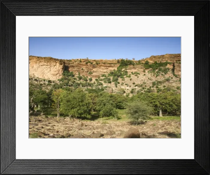 Framed Print : Dogon village of Banani with ancient Tellem dwellings underneath the Bandiagara Escarpment Framed Print : Dogon village of Banani with ancient Tellem dwellings underneath the Bandiagara Escarpment